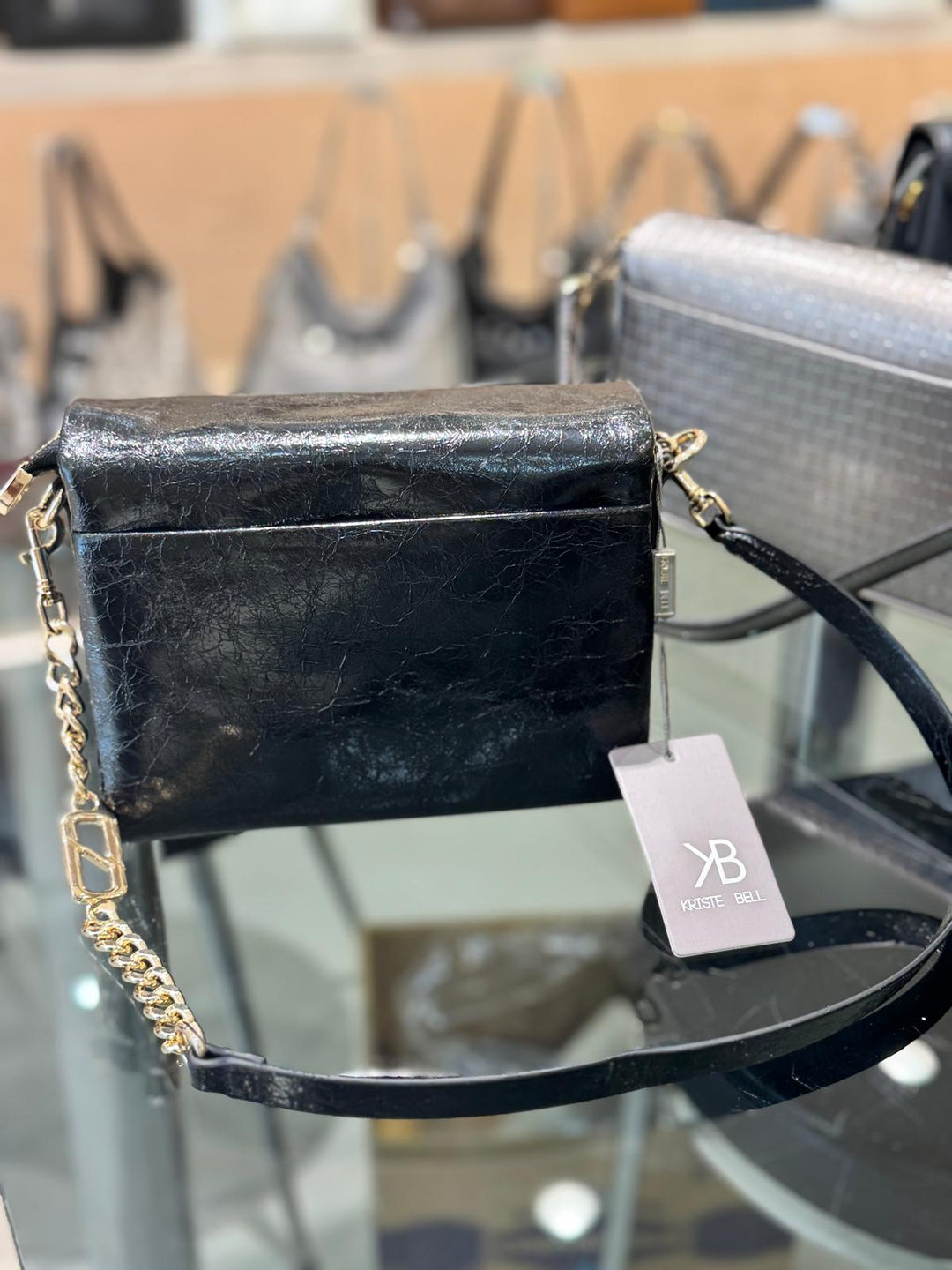 Black textured handbag with gold chain