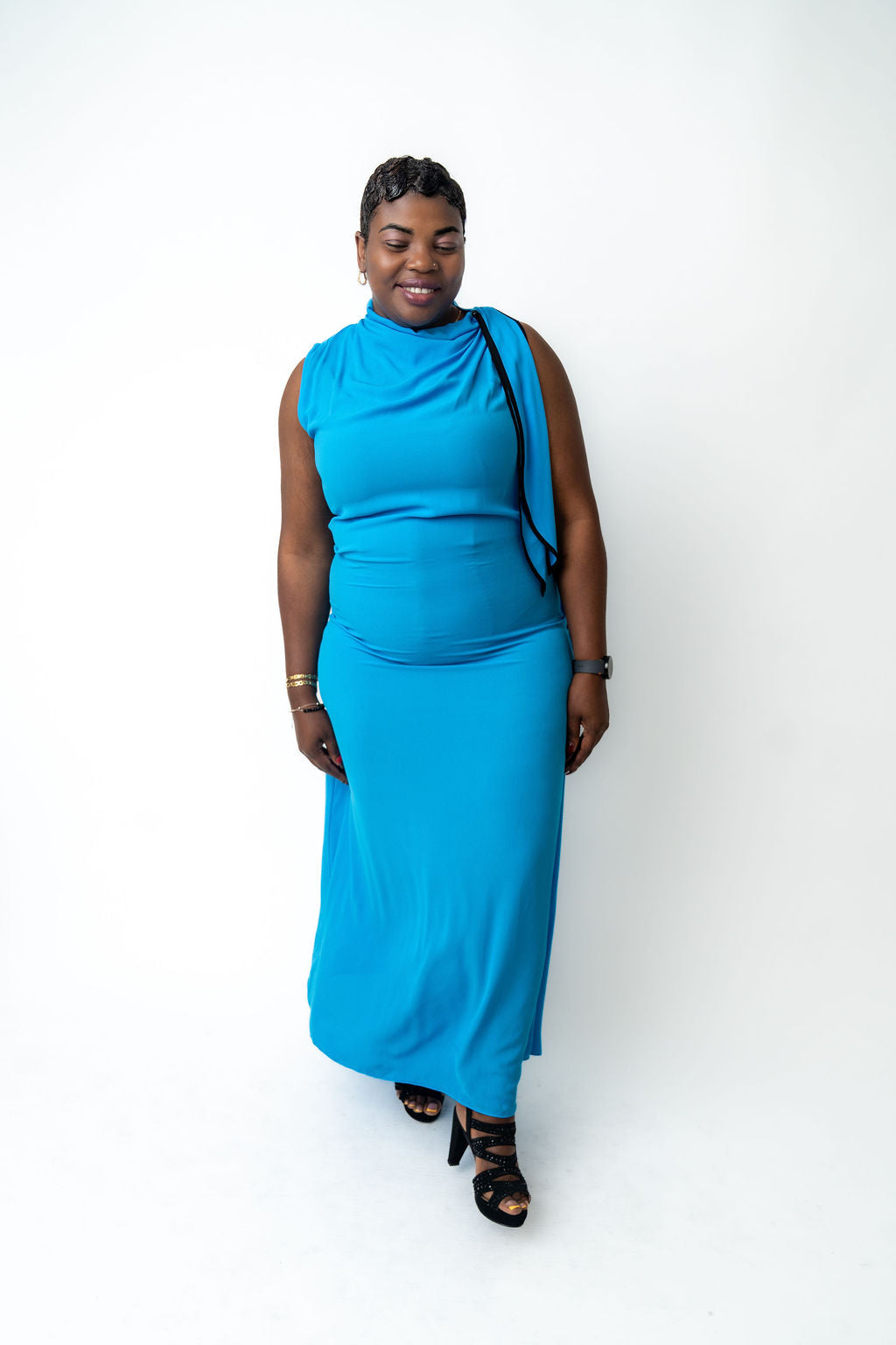 Woman wearing a blue dress against a white background