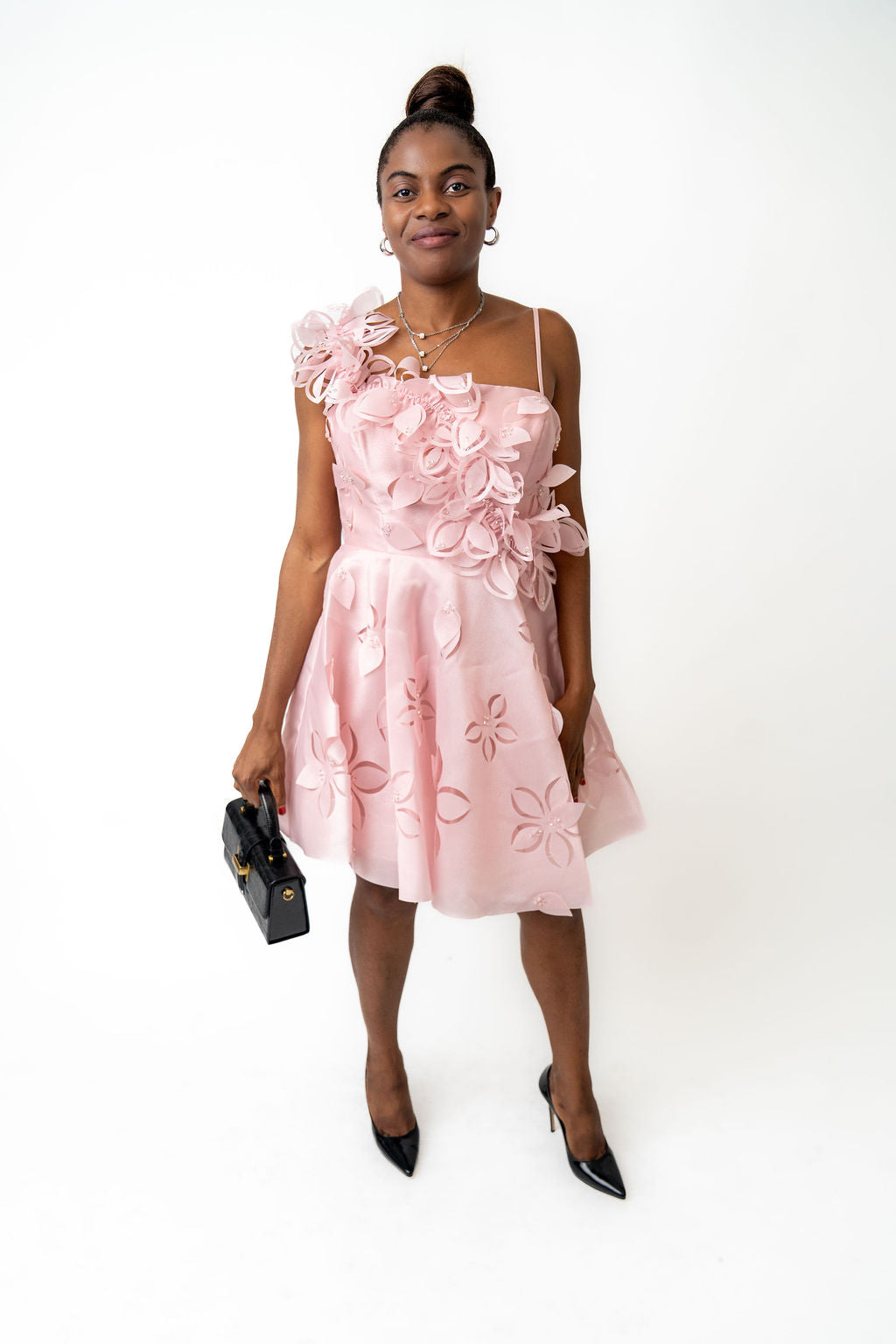 Woman wearing a pink floral dress on a white background