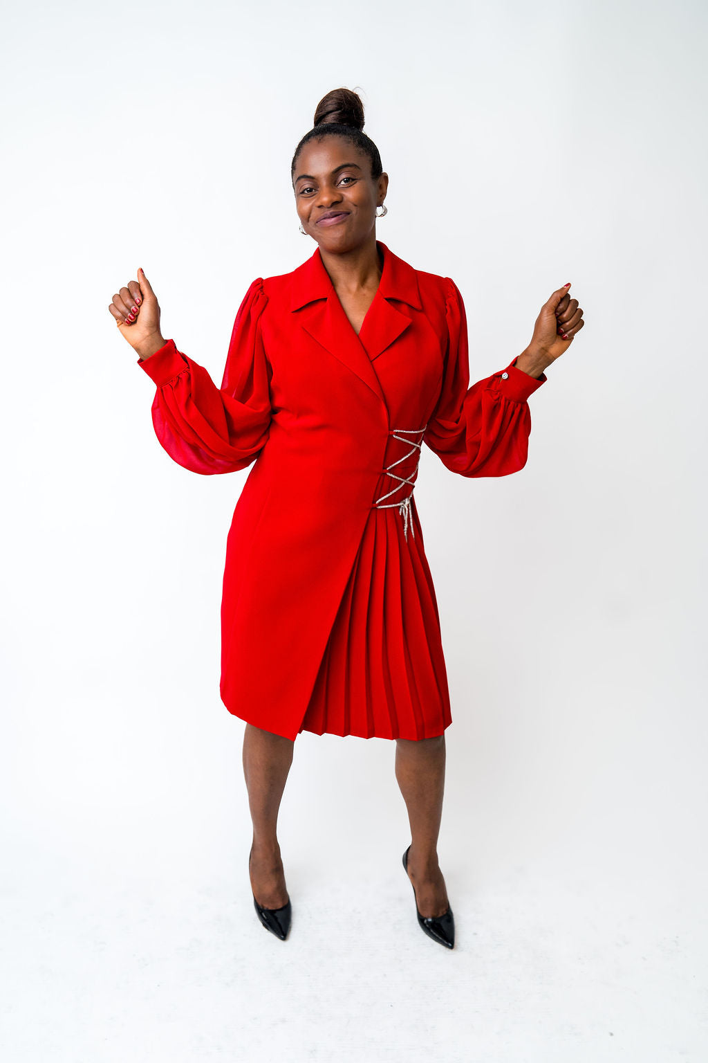 Woman wearing a red dress with a white background