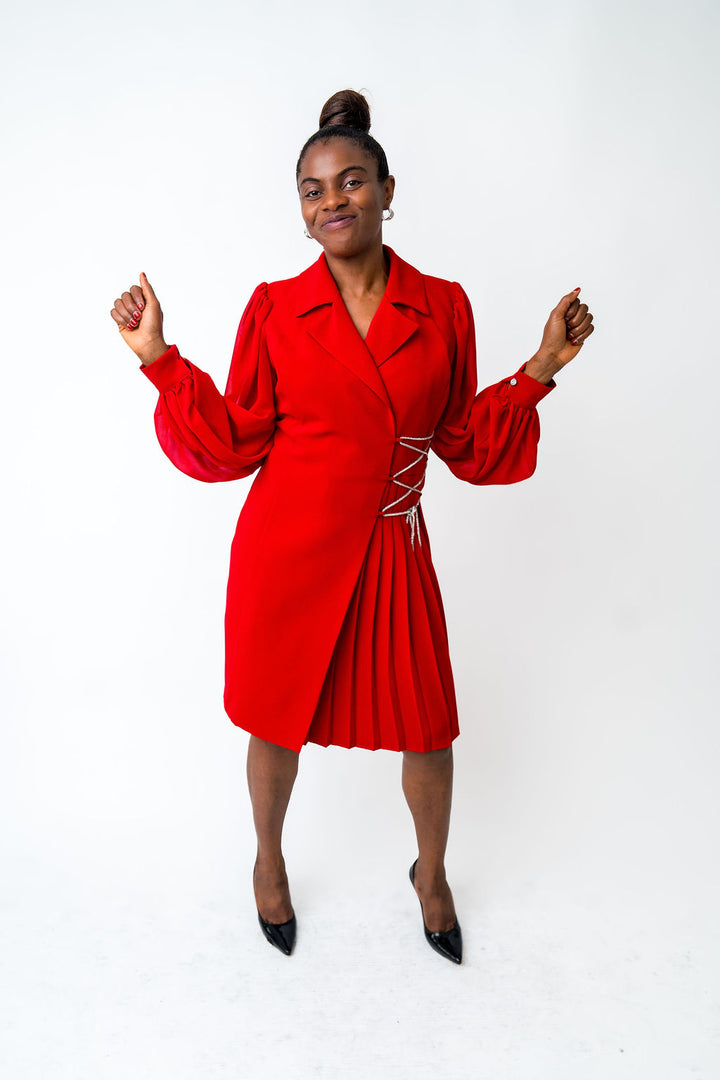 Woman wearing a red dress with a white background